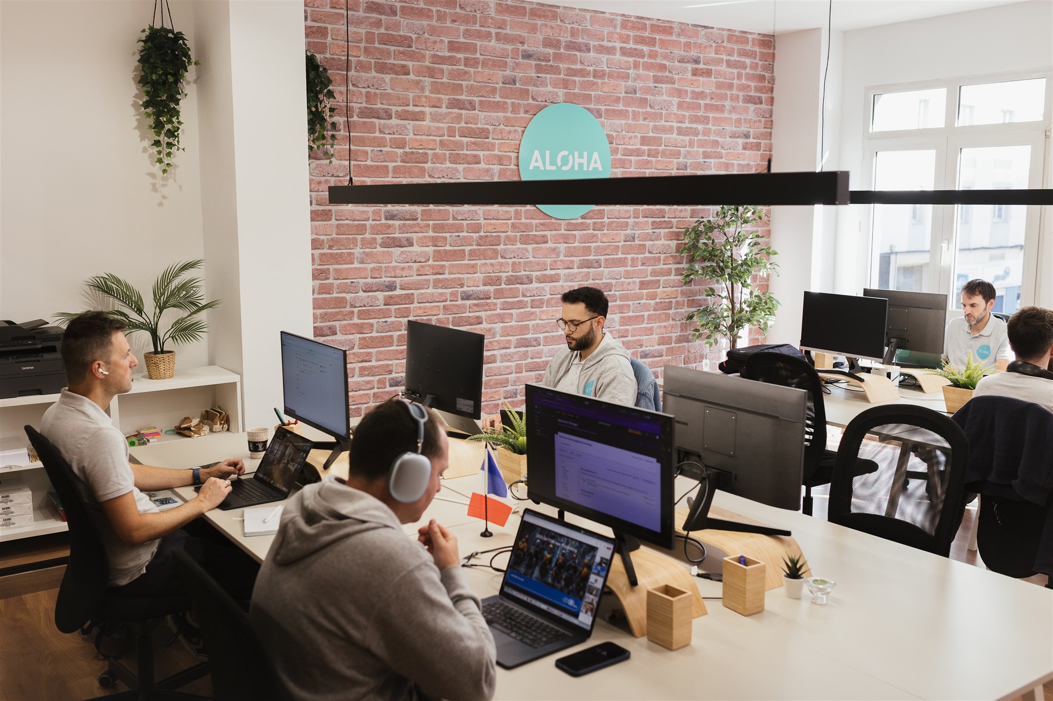 The team of Aloha Clouds working at the office, a ServiceNow Partner company